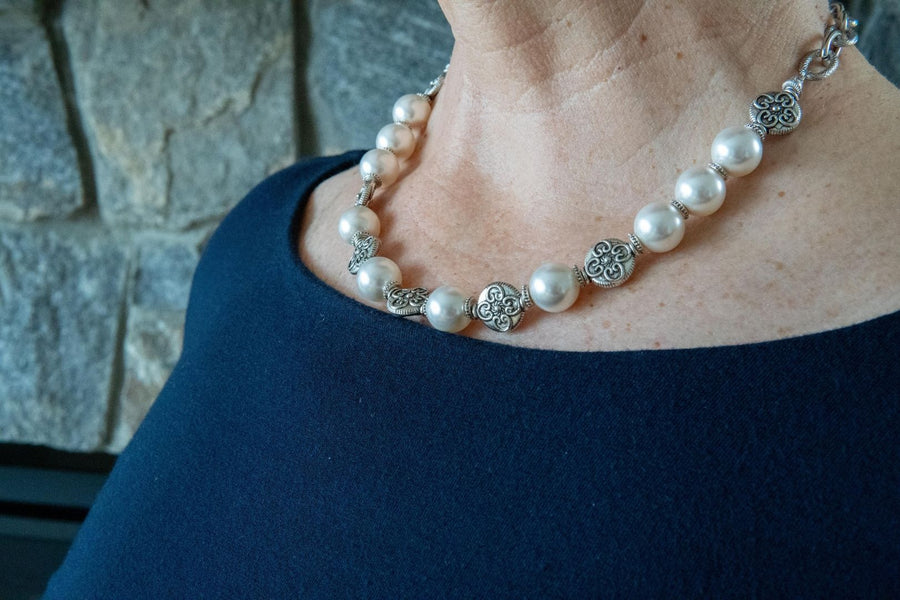 Pewter and white pearl necklace on woman's neck