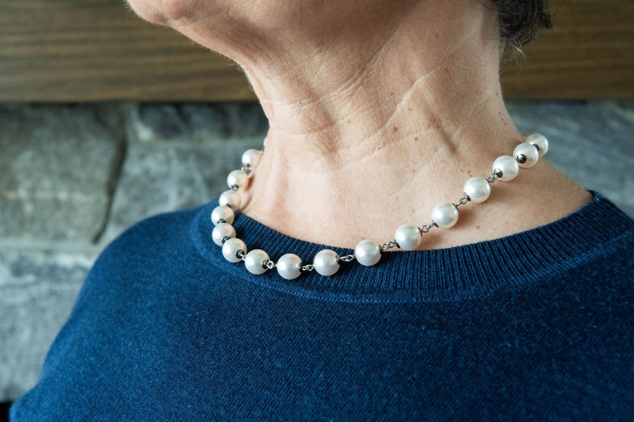 White pearl strand necklace on woman's neck