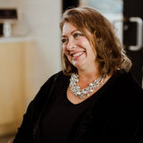 Woman wearing  a silver, crystal and European crystal pearl statement necklace