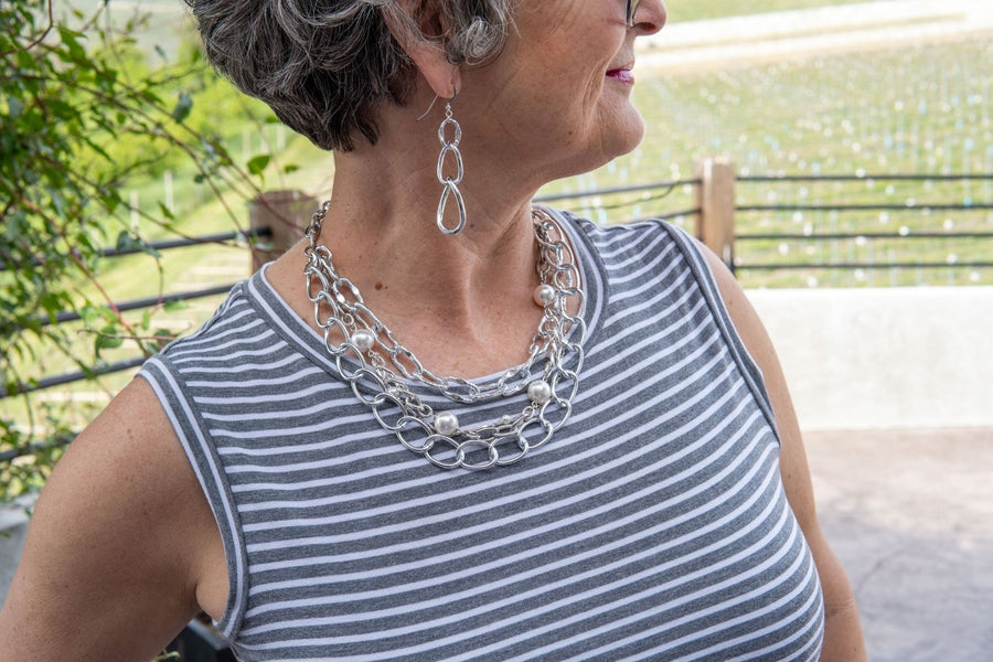 Silver chain earrings on woman