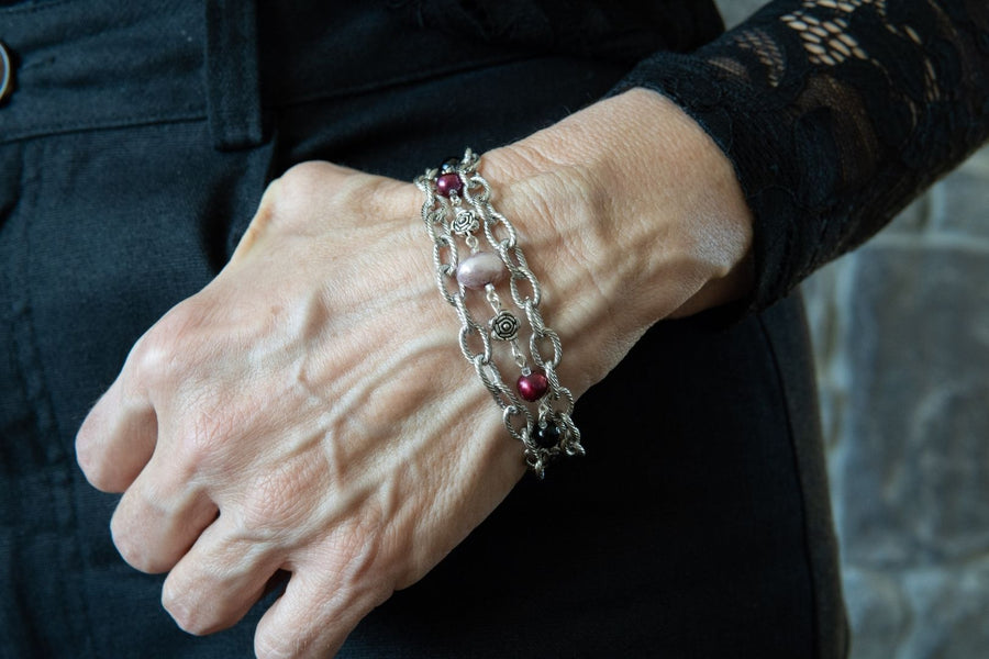 Woman wearing a gemstone, pearl and silver bracelet