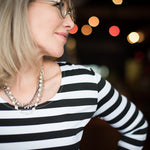 Woman wearing a silver and European crystal and crystal pearl necklace