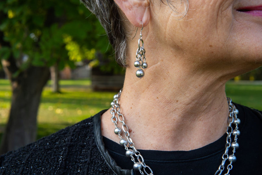 Grey pearl and silver earrings on woman