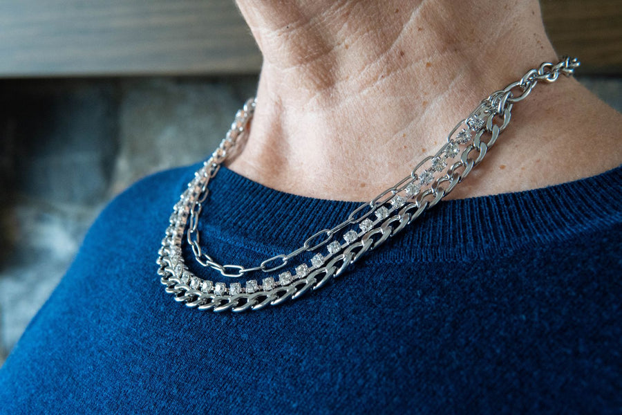 Chain & crystal necklace on woman's neck