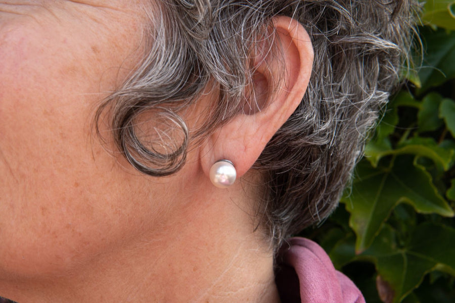 White pearl stud earring on woman
