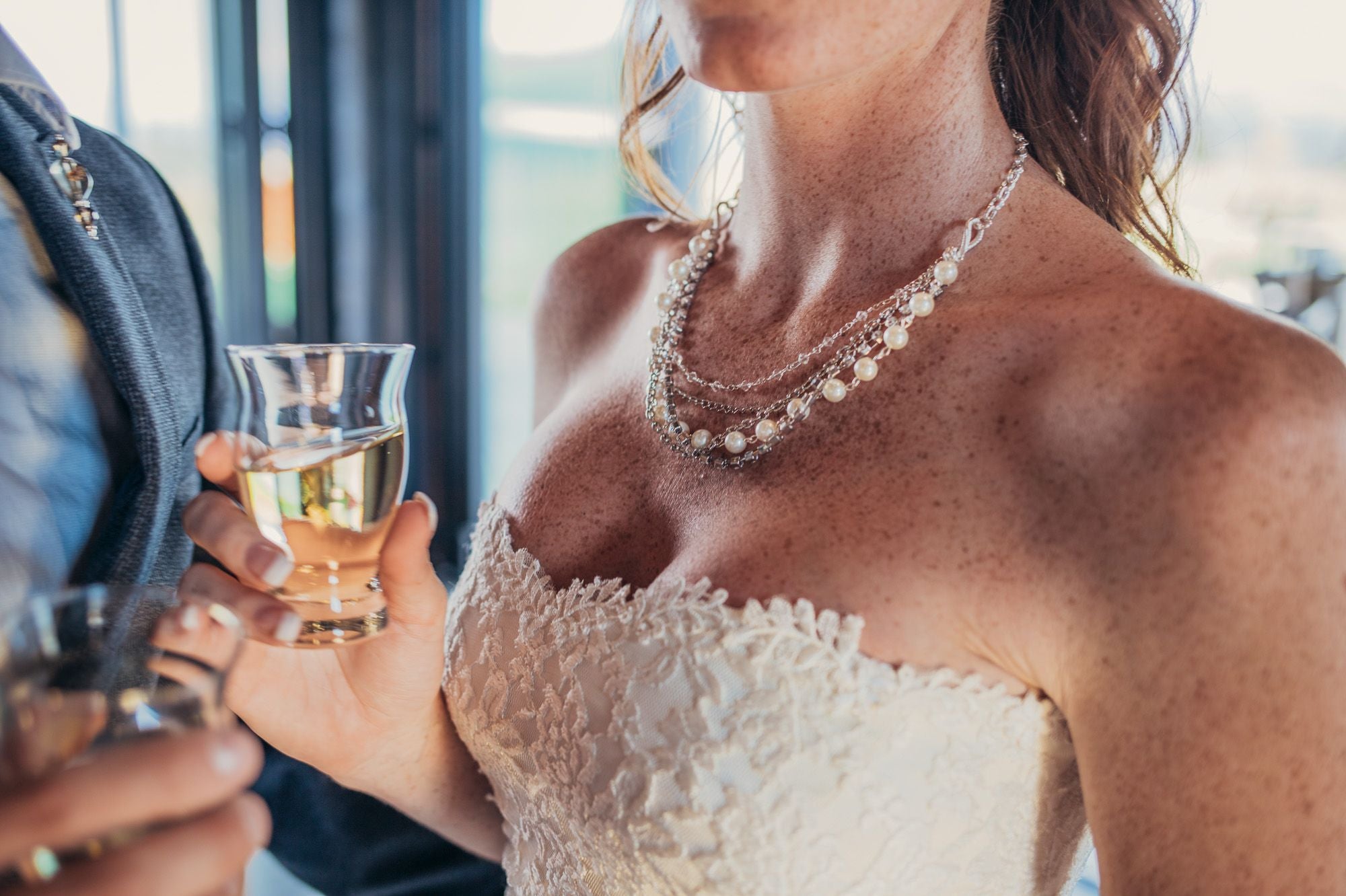 Woman wearing a silver and European crystal and crystal pearl necklace