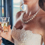 Woman wearing a silver and European crystal and crystal pearl necklace