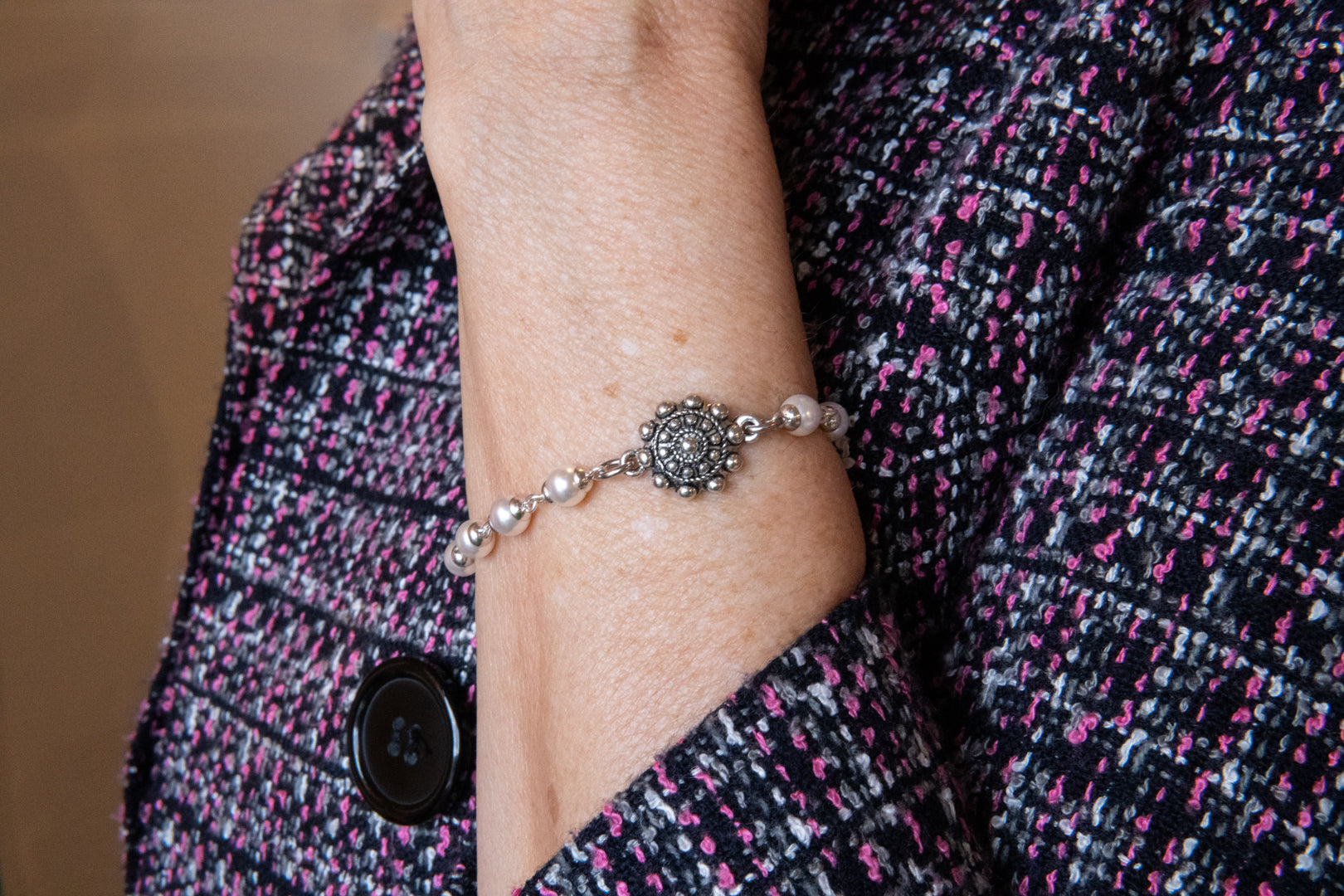 Pearl and flower bracelet on woman