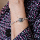 Pearl and flower bracelet on woman