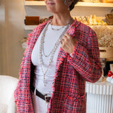 Multiple long pearl and chain necklaces on woman