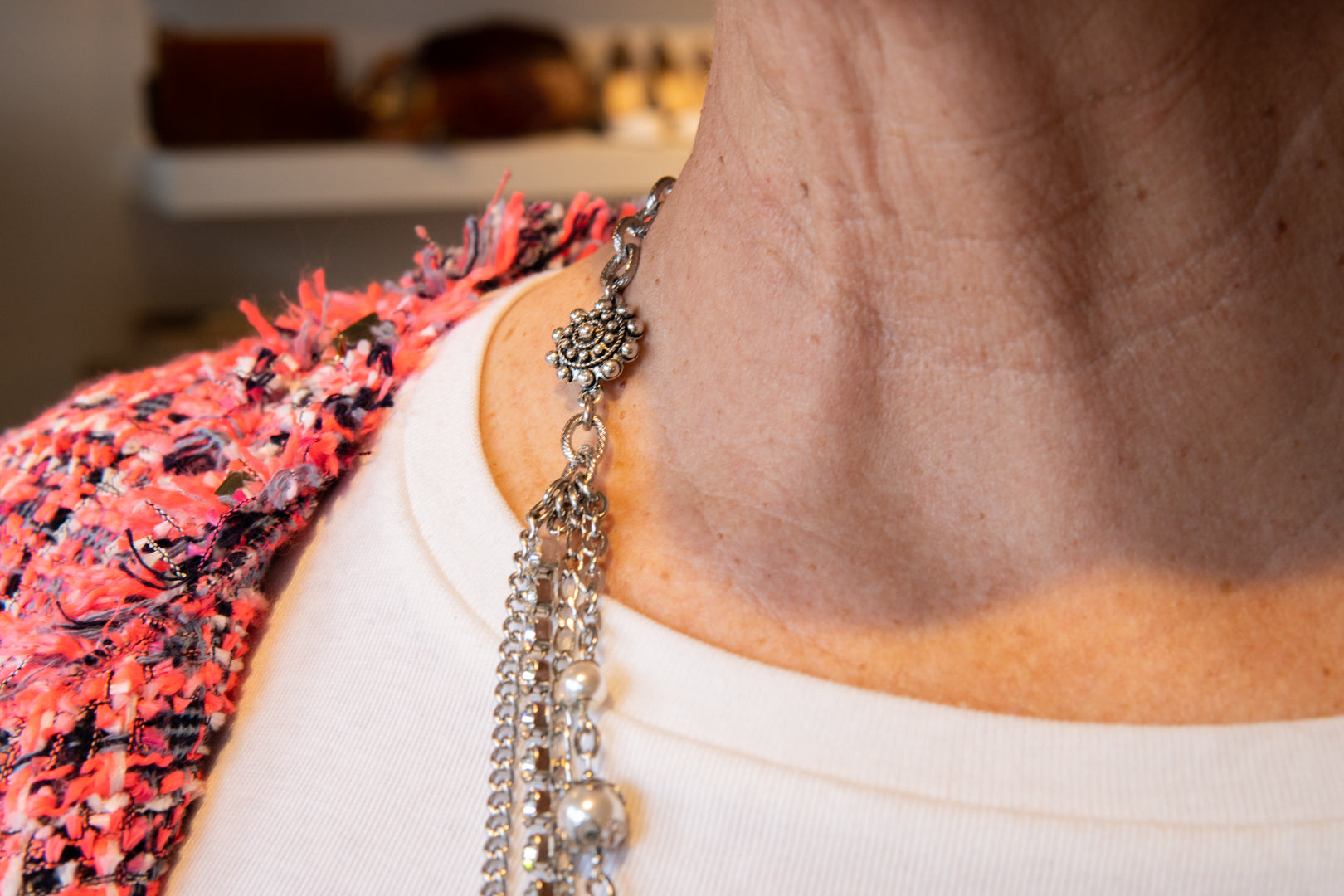 Pearl, chain and flower accent necklace on woman