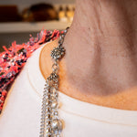 Pearl, chain and flower accent necklace on woman