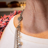 Pearl, chain and flower accent necklace on woman