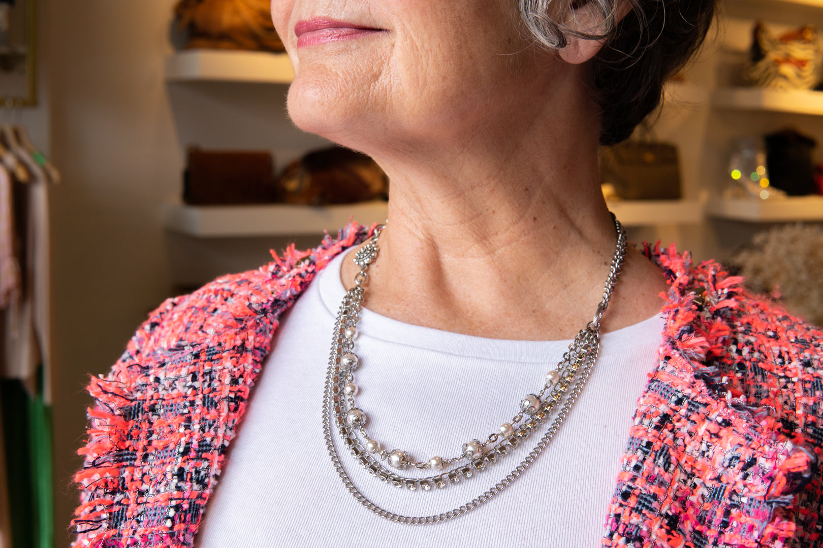 Pearl, chain and flower accent necklace on woman