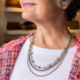 Pearl, chain and flower accent necklace on woman