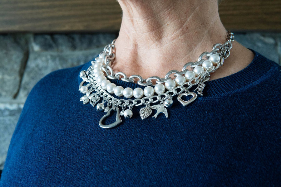 White pearl and charm necklace on woman