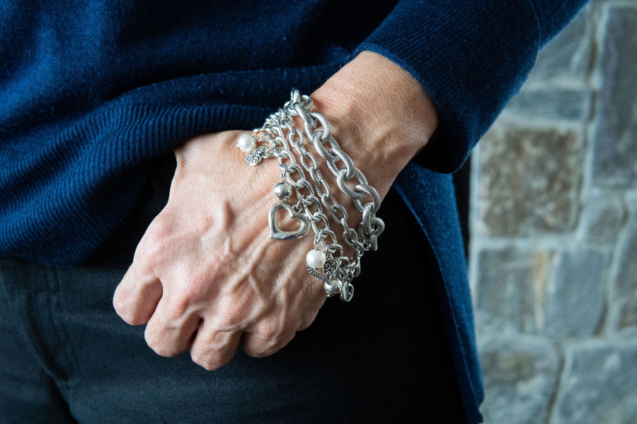 Chain and charm bracelet on woman's wrist