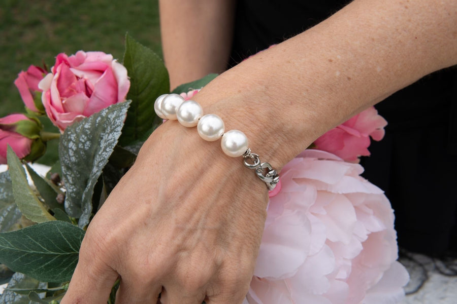 Stainless steel and pearl bracelet on woman's wrist