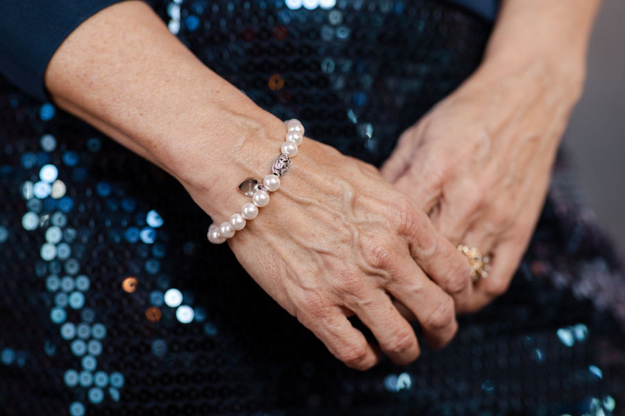 White pearl stretch bracelet on woman's wrist