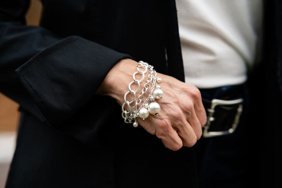 Woman's wrist wearing a silver and European crystal pearl bracelet