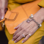 Woman wearing a pewter heart, stainless steel and European crystal pearl bracelet