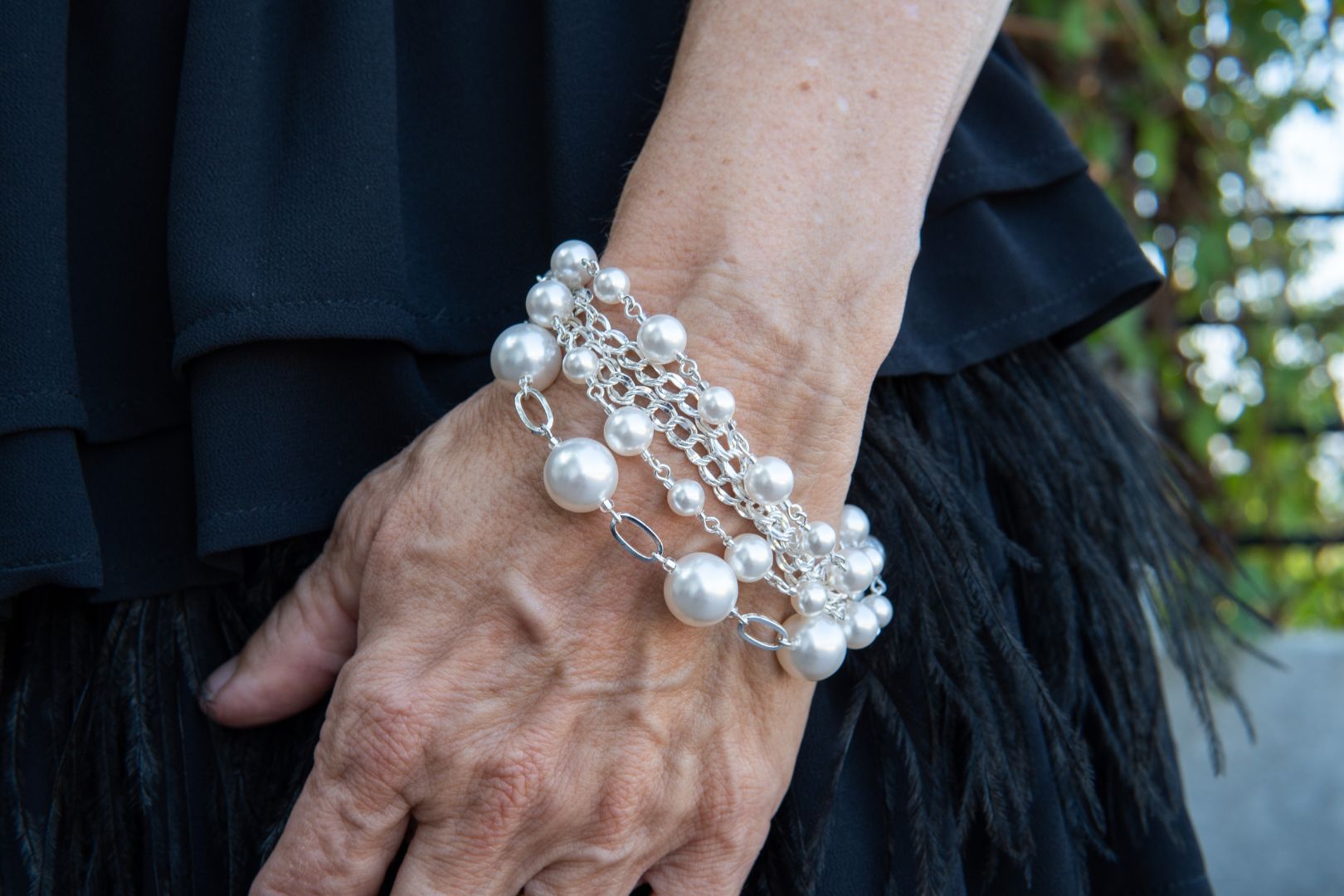 Sterling silver and pearl bracelet on woman's wrist