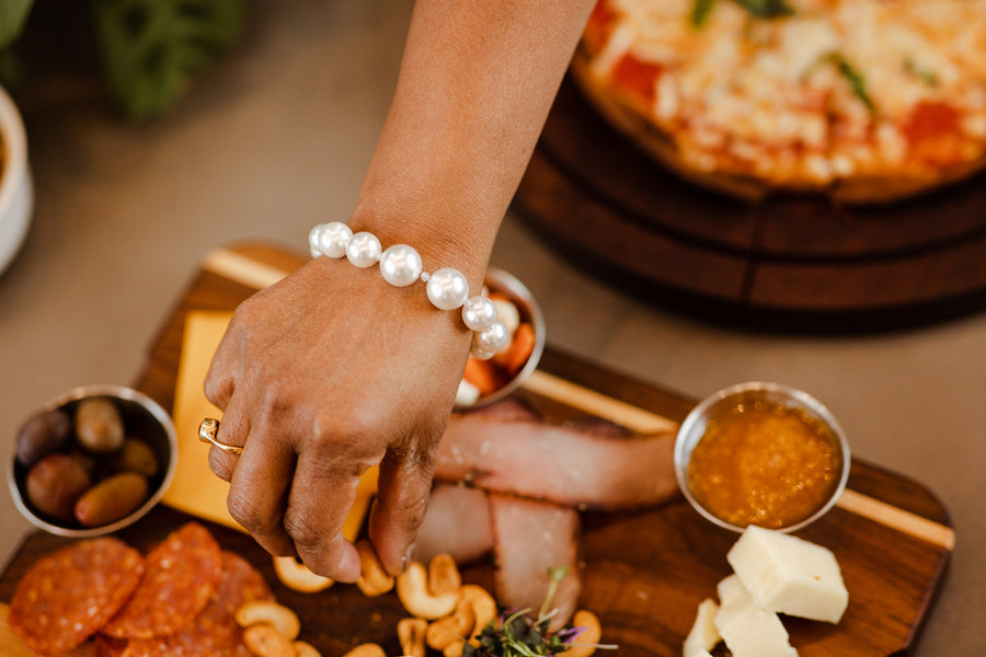 A woman wearing a white pearl bracelet