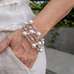 White pearl and chain bracelet on woman