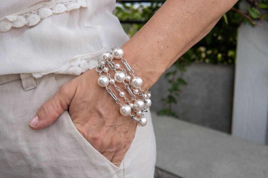 White pearl and chain bracelet on woman