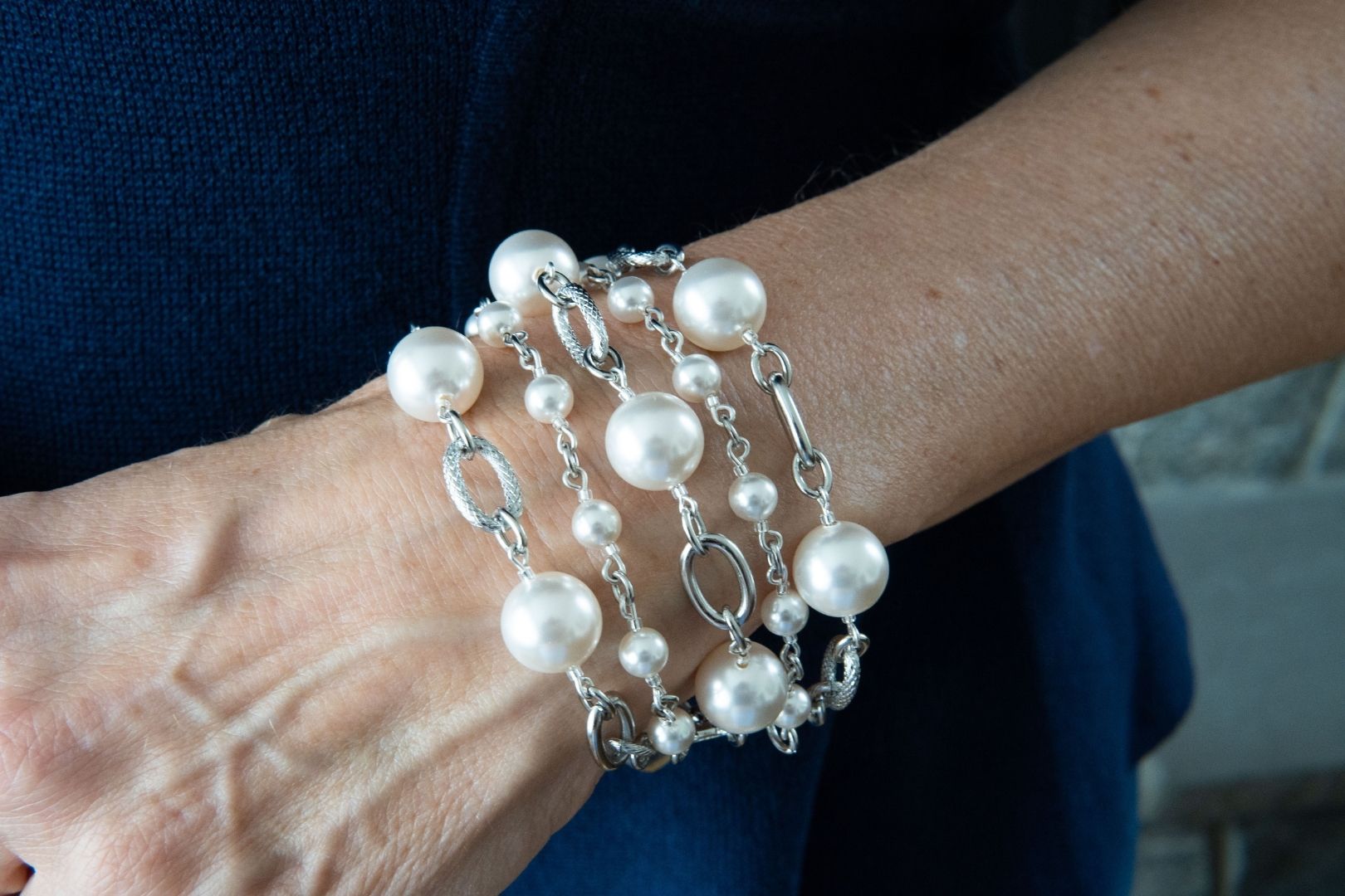 White pearl and chain bracelet on woman