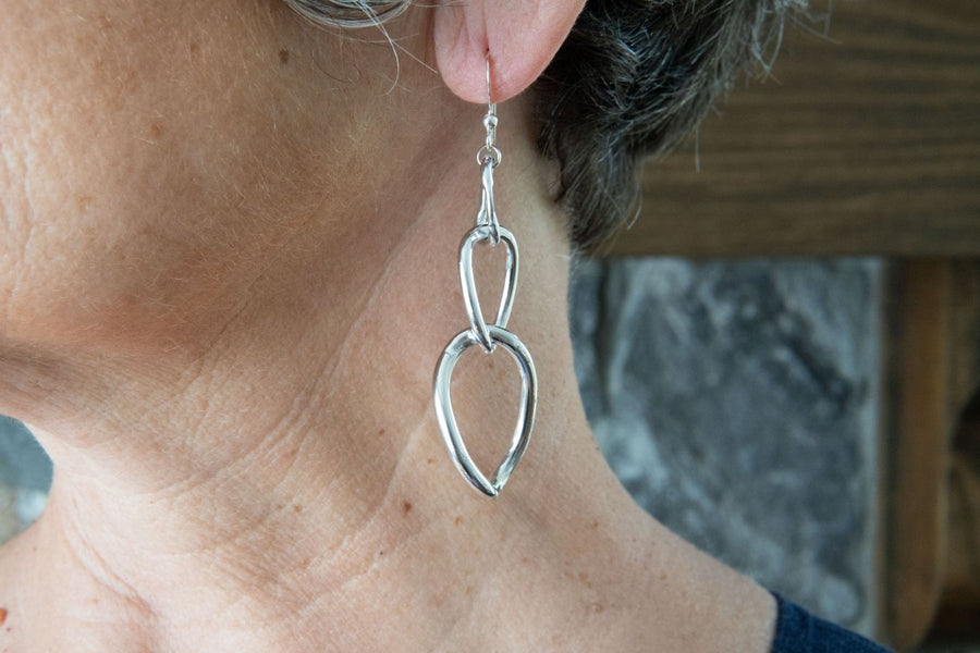 Silver chain earrings on woman