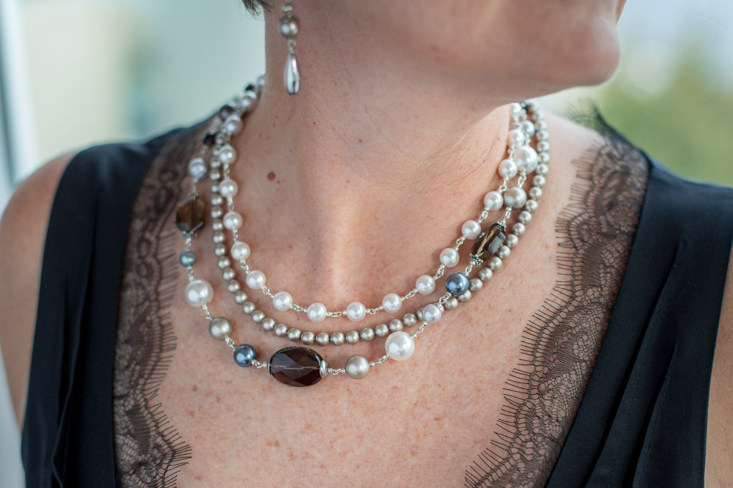 Pearl, gemstone and topaz necklace on woman