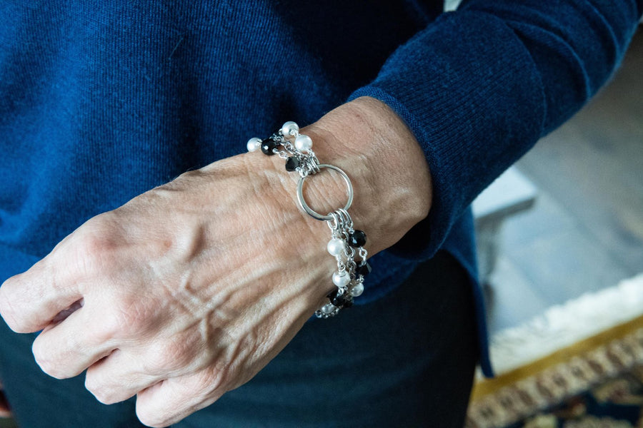 pearl and onyx bracelet on woman's wrist