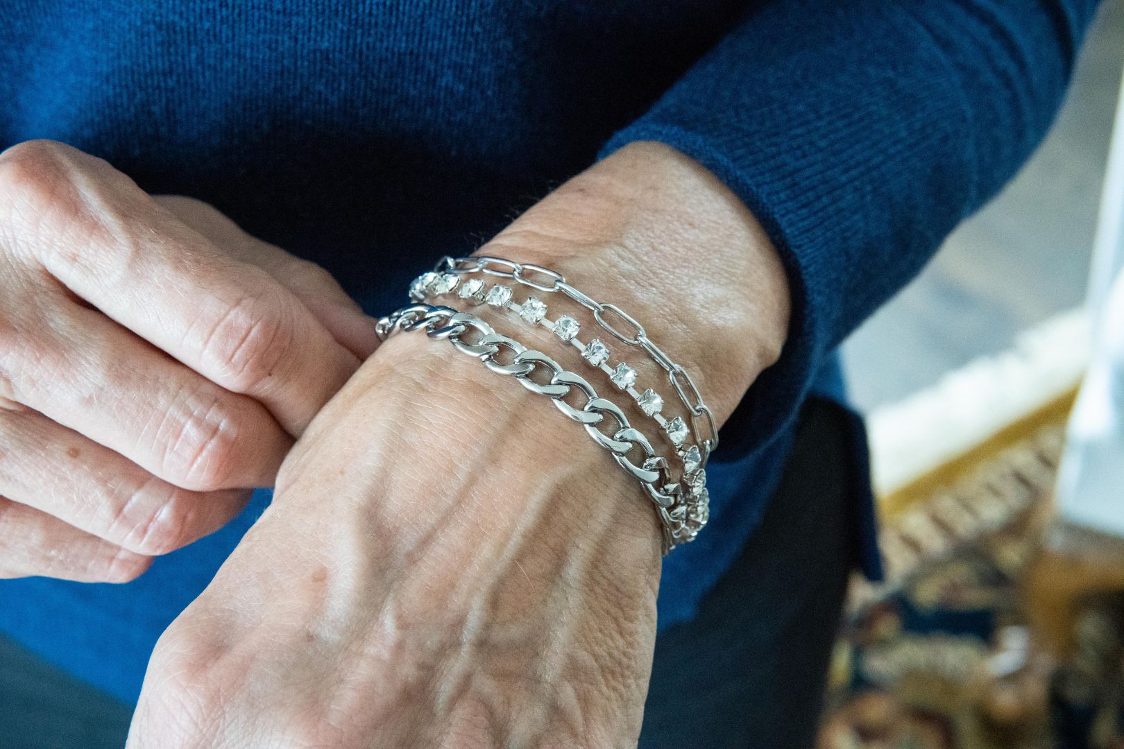Chain and crystal bracelet on woman's wrist