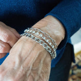 Chain and crystal bracelet on woman's wrist