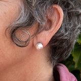 White pearl stud earring on woman