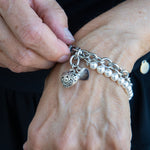 Chain and white pearl bracelet with a heart charm