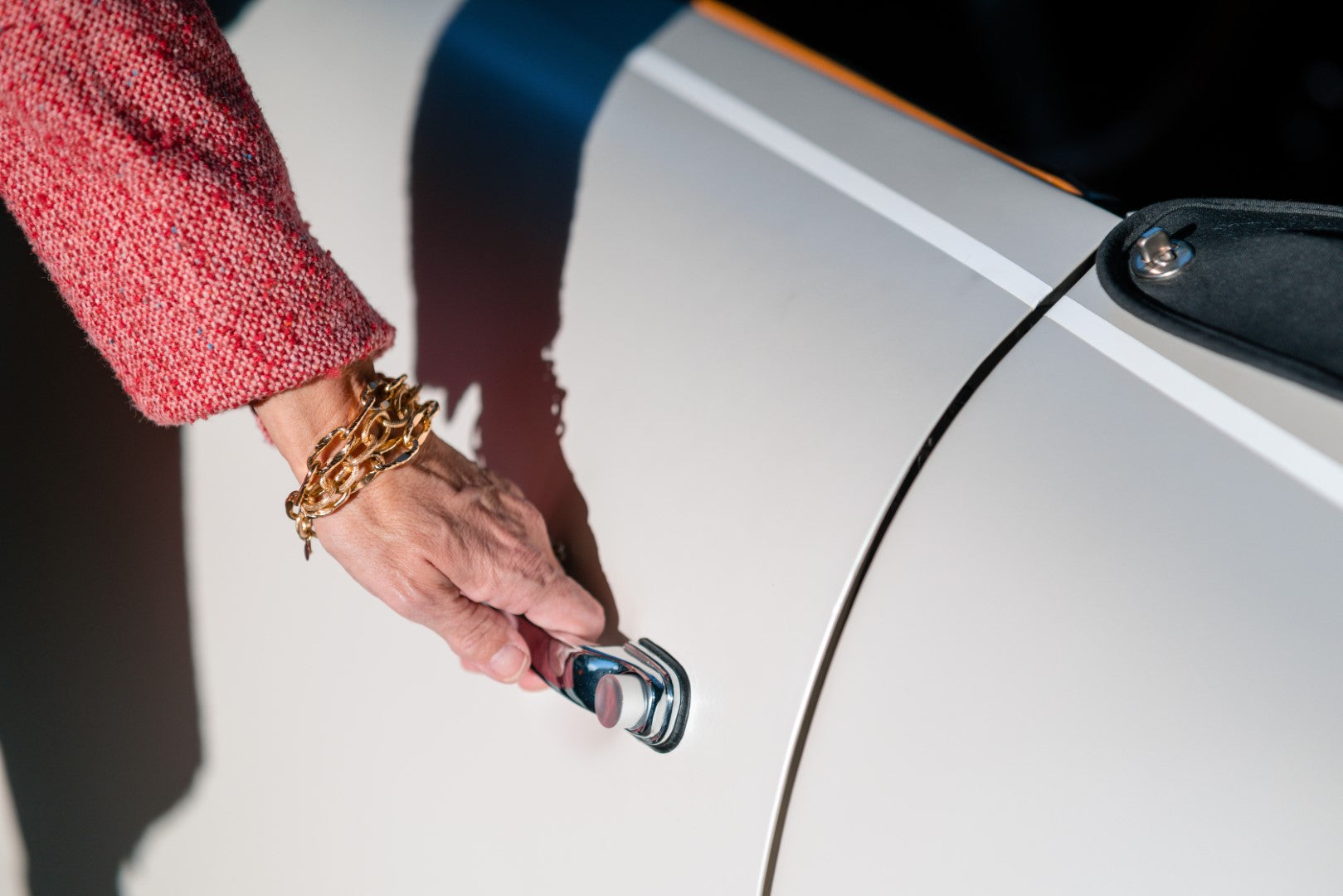 A woman's wrist with a Carolily Finery bracelet made from various gold plated chains