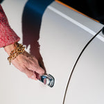 A woman's wrist with a Carolily Finery bracelet made from various gold plated chains