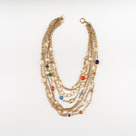 a Carolily Statement necklace made of gold plated chain, various gemstones and freshwater pearls