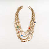 a Carolily Statement necklace made of gold plated chain, various gemstones and freshwater pearls
