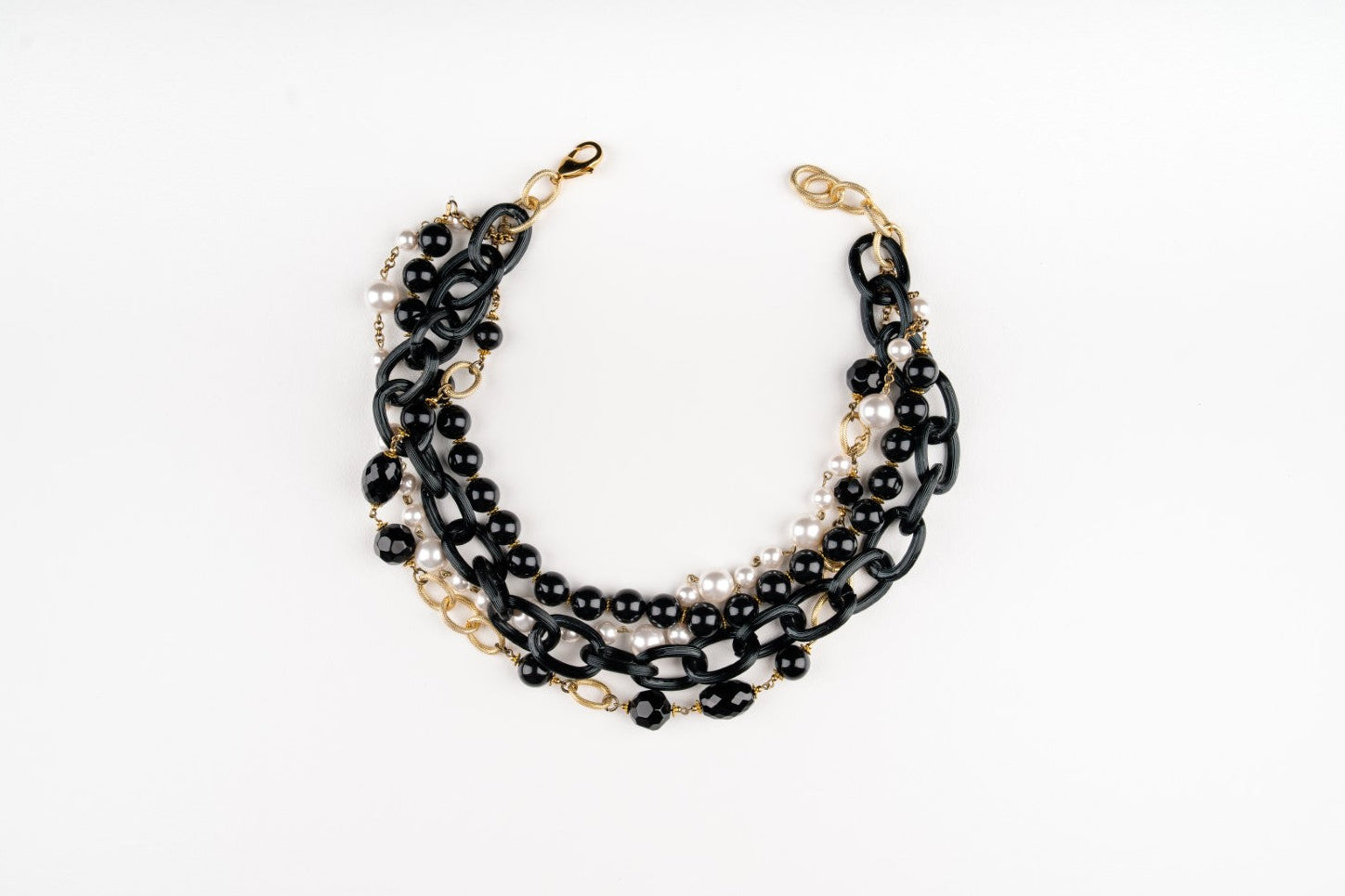 a Carolily Finery statement necklace made from onyx, Swaorvski crystal, gold plated chains and pearls