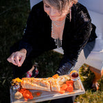 A woman in a velvet blazer wearing a Carolily Finery statement necklace made from silver plated chain and European  crystal pearls