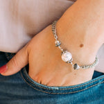 a woman's wrist wearing a Carolily Finery bracelet made from European pearl, sterling silver beads, silver accents, antiqued silver chains