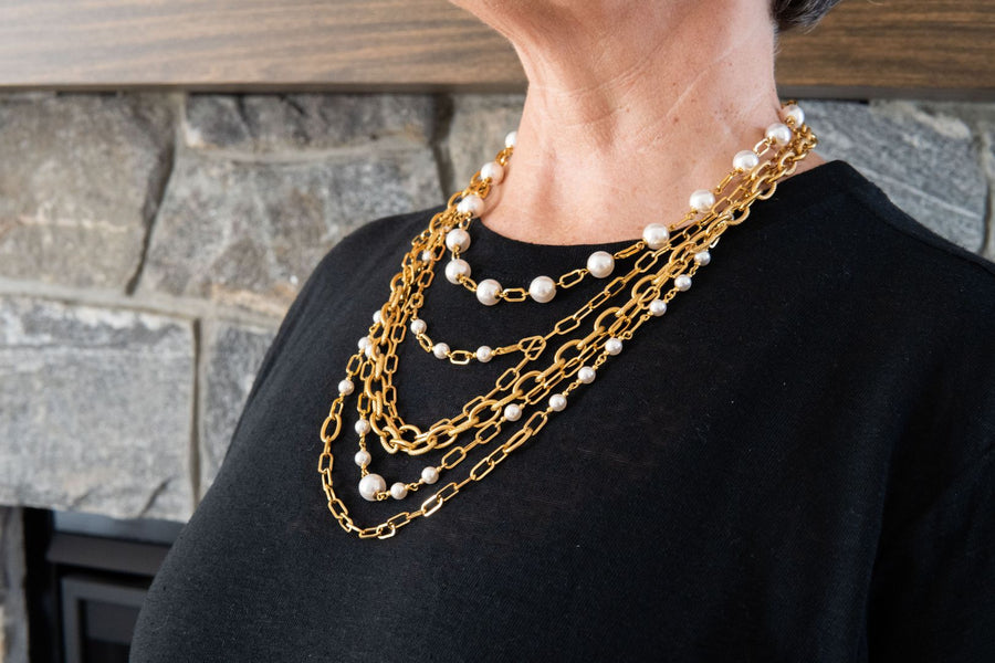 Three gold necklaces layered